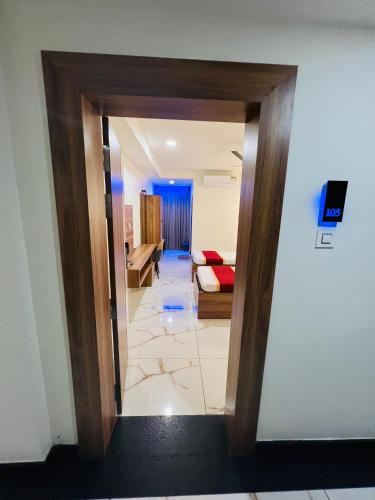 a view of a living room and a hallway at Shanthi Tourist Home in Pathanāmthitta