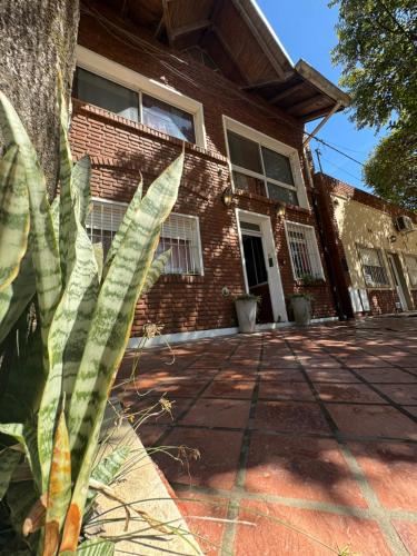 a brick house with a palm tree in front of it at HColon in Colón
