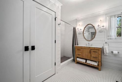 a white bathroom with a sink and a mirror at Private Retreat Burwood 8 acres Hot Tub Fire pit in Spring Hill