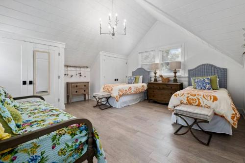 a bedroom with two beds and a chandelier at Private Retreat Burwood 8 acres Hot Tub Fire pit in Spring Hill