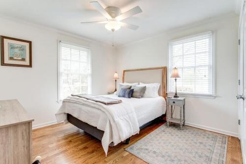 a white bedroom with a bed and a ceiling fan at Birdsong Retreat Hot Tub Grill Fire Pit in Franklin