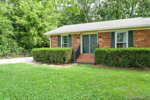 a brick house with a green door in a yard at Sunset Stay Pet Friendly 2bed 1 bath in Murfreesboro