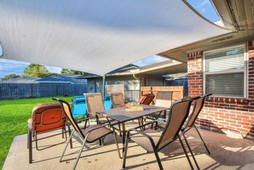 a patio with a table and chairs on a porch at Family Fun Oasis Pool Hot Tub and Play Area in Houston