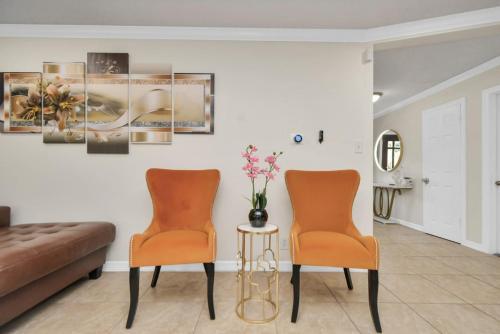 two chairs and a table in a living room at Family Fun Oasis Pool Hot Tub and Play Area in Houston