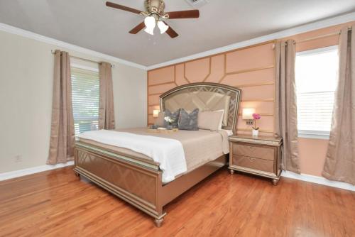 a bedroom with a bed and a ceiling fan at Family Fun Oasis Pool Hot Tub and Play Area in Houston