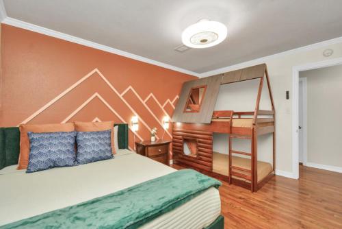 a bedroom with a bed and a desk and a piano at Family Fun Oasis Pool Hot Tub and Play Area in Houston