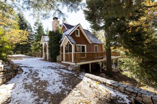 a house with a porch and a stone wall at Hideaway at Gingerbread Gardens in Twin Peaks