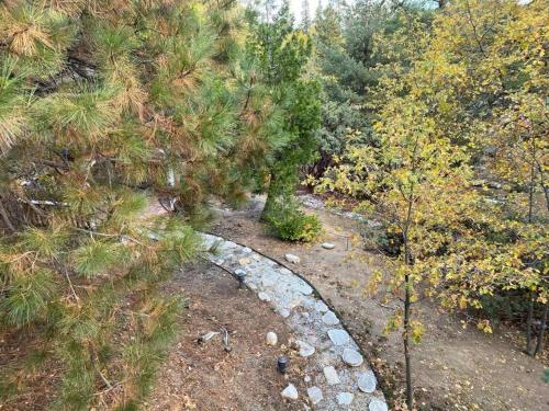 an overhead view of a stone path in a forest at Hideaway at Gingerbread Gardens in Twin Peaks