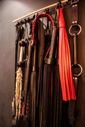 a bunch of umbrellas hanging on a rack at The Hidden Dungeon in Brighton & Hove