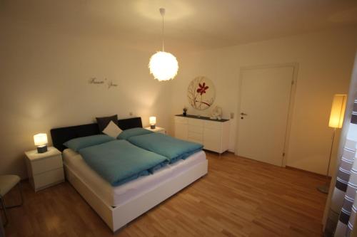 a bedroom with a bed with blue pillows at Appartement Romantikstadt Steyr in Steyr