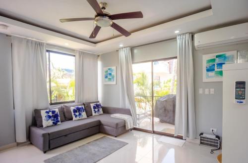 a living room with a couch and a ceiling fan at Beautifully updated in the heart of town in Cabarete