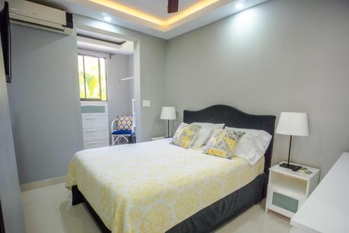 a bedroom with a bed in a room with a window at Beautifully updated in the heart of town in Cabarete
