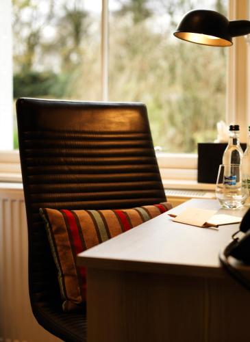 a chair sitting at a desk with a lamp at 24 Royal Terrace in Edinburgh