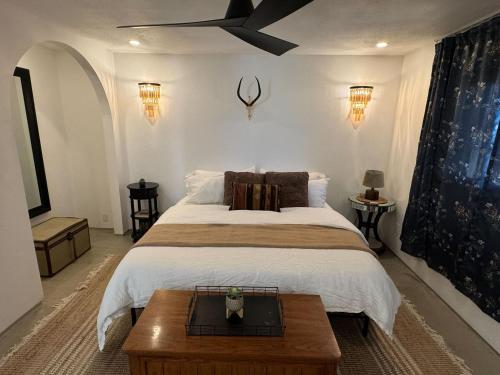 a bedroom with a large bed with a wooden coffee table at The Castle House Estate in Joshua Tree