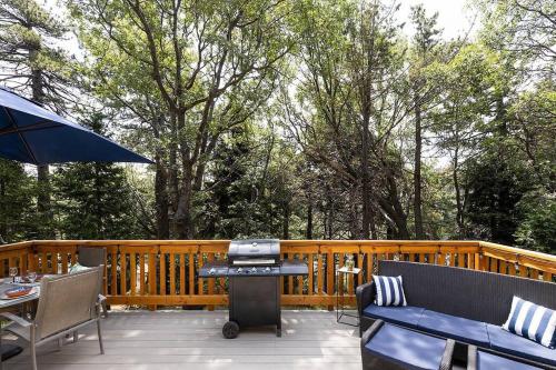 a patio with a grill and a table and chairs at One With Nature in Crest Park