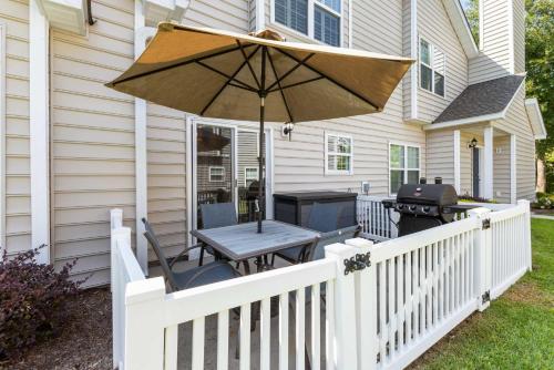 a white fence with a table and an umbrella at Fairway Oaks Unit 57B in Myrtle Beach