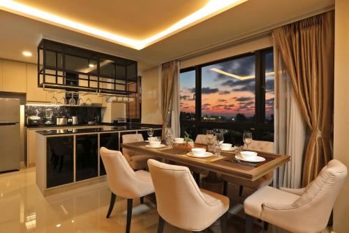 a kitchen and dining room with a table and chairs at 3bdr SeaView Apartment in Surin Beach by Capital Pro in Phuket Town