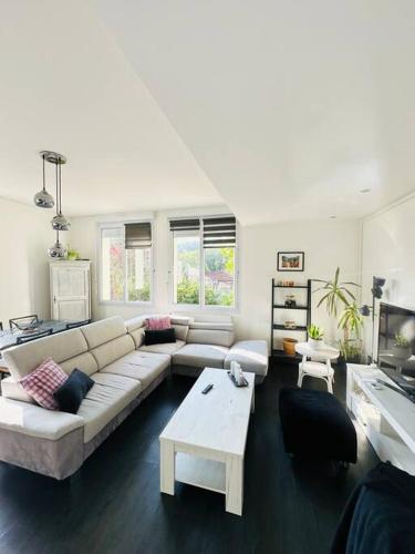 un salon avec un canapé et une table dans l'établissement Le Saint Jean, à Montcy-Saint-Pierre