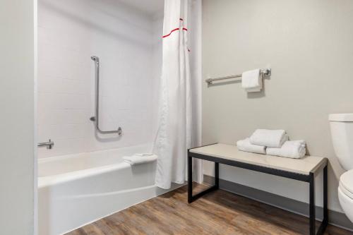 a bathroom with a tub and a toilet and a sink at Red Roof Inn Dunn in Dunn