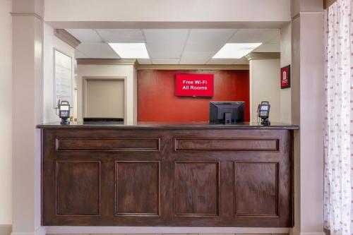 a bar in a waiting room with a red sign at Red Roof Inn Dunn in Dunn