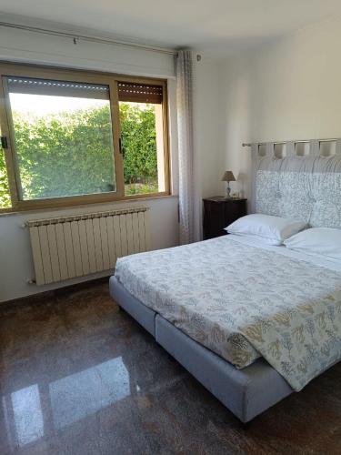 a bedroom with a large bed and a window at Regina sul Mare in Terracina
