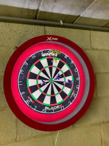 a dart board hanging on a brick wall at Villa Luna in Oudsbergen 