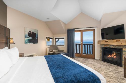 a bedroom with a bed and a fireplace at Grand Superior Lodge in Castle Danger