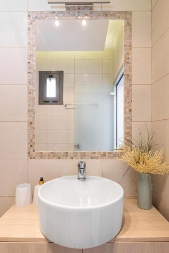 a white sink in a bathroom with a mirror at Sensi resort Nikiti in Nikiti