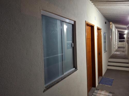 a large glass window on the side of a building at Suíte Casa de Luz-Lar na Serra-quarto 03 in Miguel Pereira