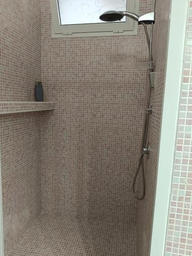 a bathroom with a shower with a window at Regina sul Mare in Terracina