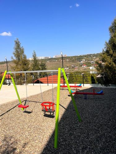 a group of swings in a playground at Lake View Apartment Iasi in Valea Lupului
