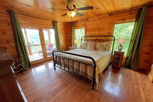 a bedroom with a bed in a log cabin at Smoky Mountain High in Bryson City
