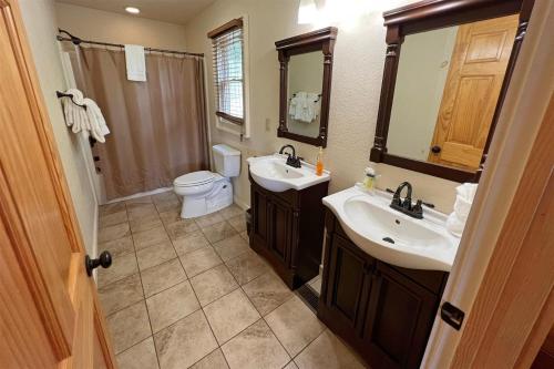 a bathroom with two sinks and a toilet at Smoky Mountain High in Bryson City