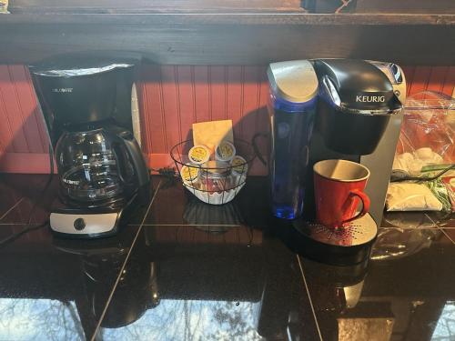 a counter with a coffee maker and a coffee mug at Sunset Vista in Bryson City