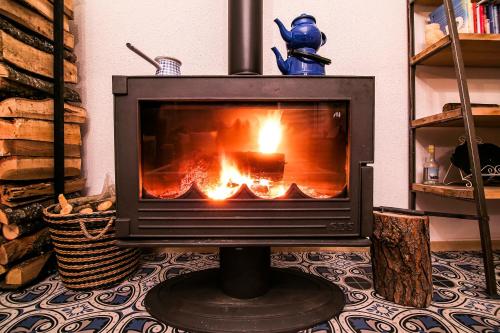 a fireplace in a living room with a fire in it at Gobene Alacati in Alacati