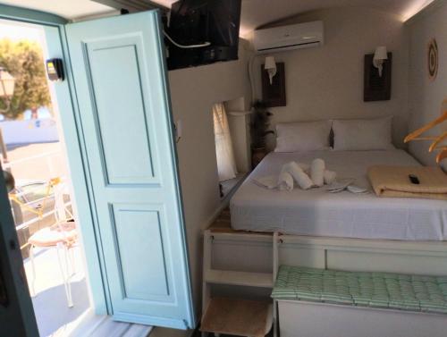 a small bedroom with a bed with towels on it at Calliste Nest In Kasonia, Pothia Harbour in Kalymnos