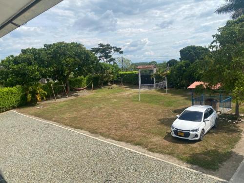 a white car parked in a parking lot at HotelSueños de Acapulco-Eje cafetero-Quindio in Montenegro