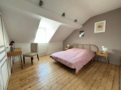 a bedroom with a bed and a desk and a window at Maison au calme quartier Lancrel in Alençon