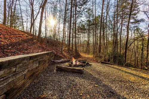 a road in the woods with a fire on the side at White Tail Hollow in Roundhill