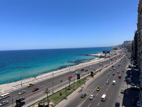 a busy road with cars on it next to a beach at Haidar Private bedroom for Men only غرف خاصه للرجال فقط 仅限男性 in Alexandria