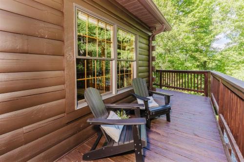 two chairs sitting on the front porch of a cabin at Wally`s Kabin in Whittier
