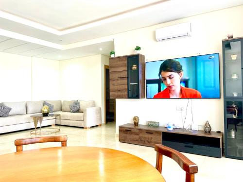 a living room with a large tv on a wall at Family Home in Agadir