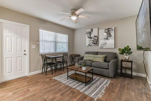 a living room with a couch and a table at Lovely 1 Bedroom Steps from the Beach in Palm Beach Shores