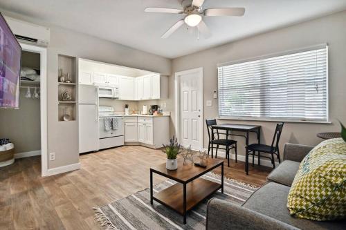 a living room with a couch and a table at Lovely 1 Bedroom Steps from the Beach in Palm Beach Shores