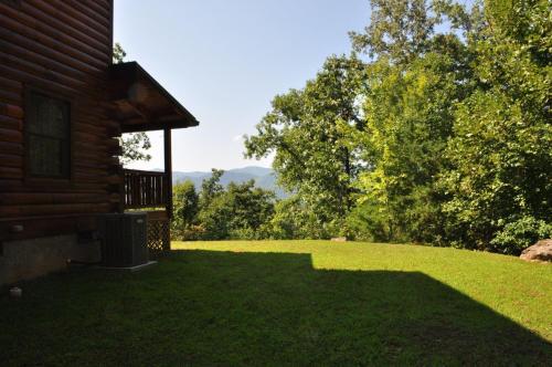 a house with a large yard with a porch at Cherokee Ridge Retreat in Whittier