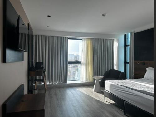 a hotel room with a bed and a large window at ONYX by luna in Oran