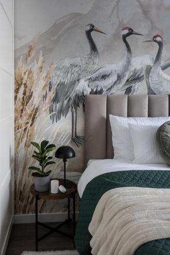 a bedroom with three birds painted on the wall at NEW #Madalińskiego57 - city center, new bulding, 2 bedrooms, 2x double beds and a fold-out sofa, separate kitchen, air conditioning, balcony, underground parking, self check in 24h, internet, Netflix, coffee machine, washing machine,1 km to the railway in Wrocław