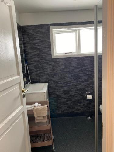 a bathroom with a tub and a sink and a window at Úthlíd Cottages in Úthlid
