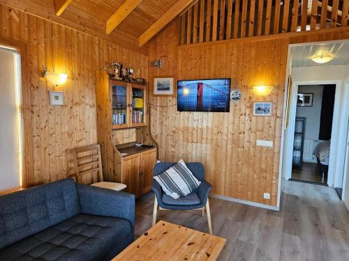 a living room with a couch and a table at Úthlíd Cottages in Úthlid