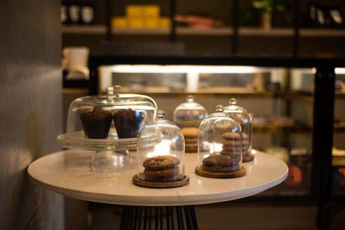 a shelf with cookies and glass jars on it at Crowne Plaza Today Gurugram by IHG in Gurgaon